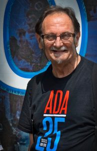 Portrait of Tom Olin wearing and ADA25 shirt