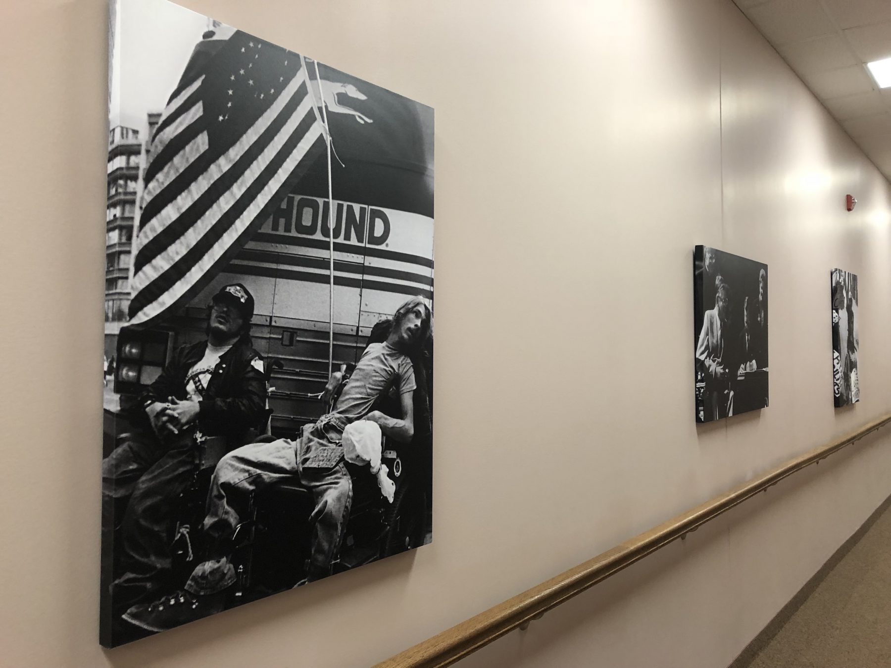 Office hallway with hand railing and Tom Olin's black and white photos hung on the wall