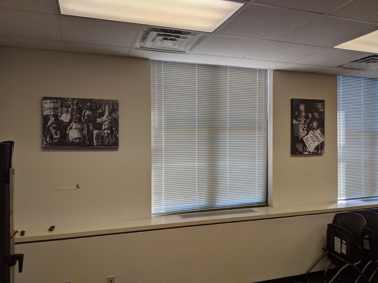 A meeting room with Tom Olin's black and white photos hung on the wall