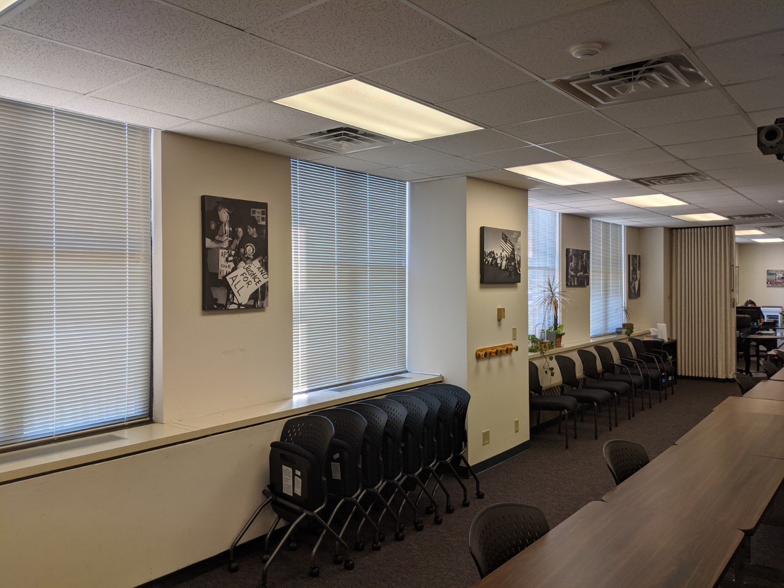 A meeting room with Tom Olin's black and white photos hung on the wall