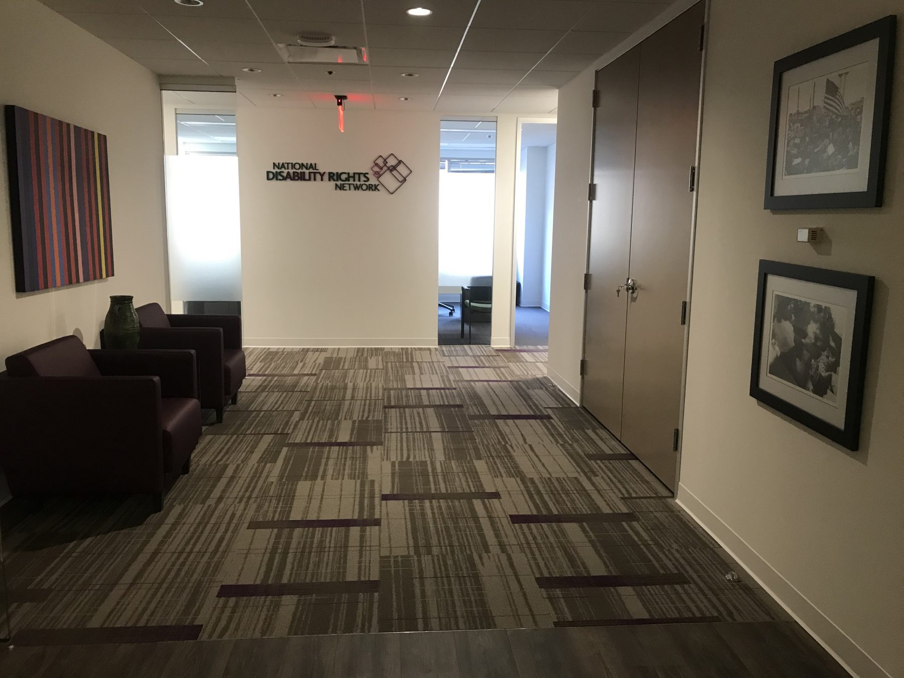 Lobby with the National Disability Rights Network logo on the wall and two Tom Olin black and white photos hung up