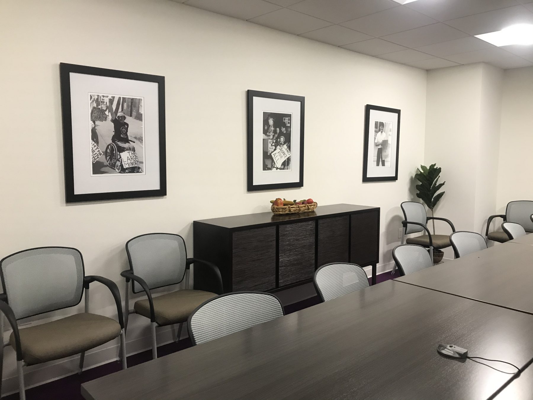 Meeting room with three black and white Tom Olin works hung in black frames