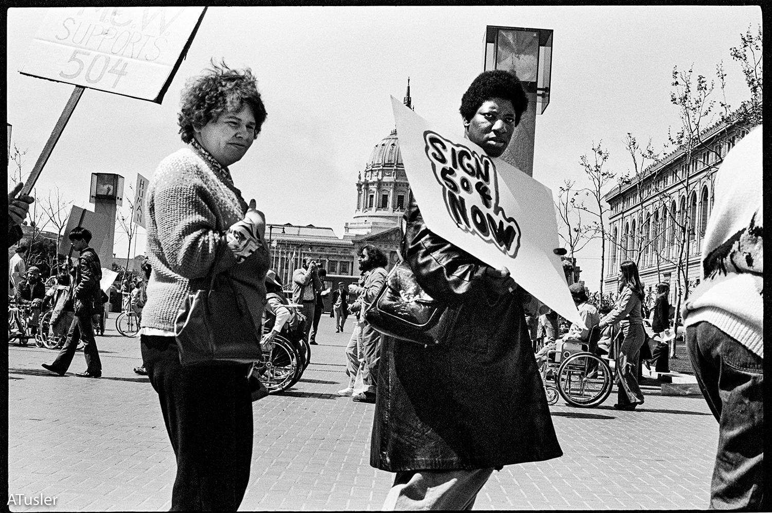 Black and white photo of two people in front of the building rotunda