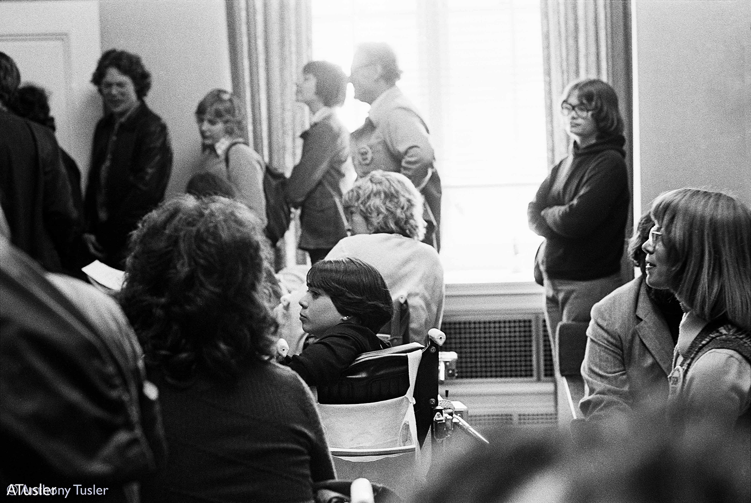 Black and white photo of people looking away from the camera